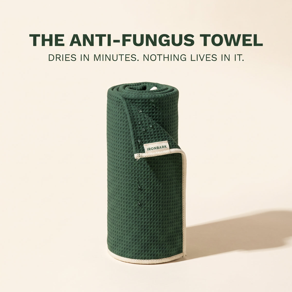 NAIA IronBark quick-dry microfiber towel displayed folded and spread out, showcasing its soft, lightweight, and absorbent fabric.